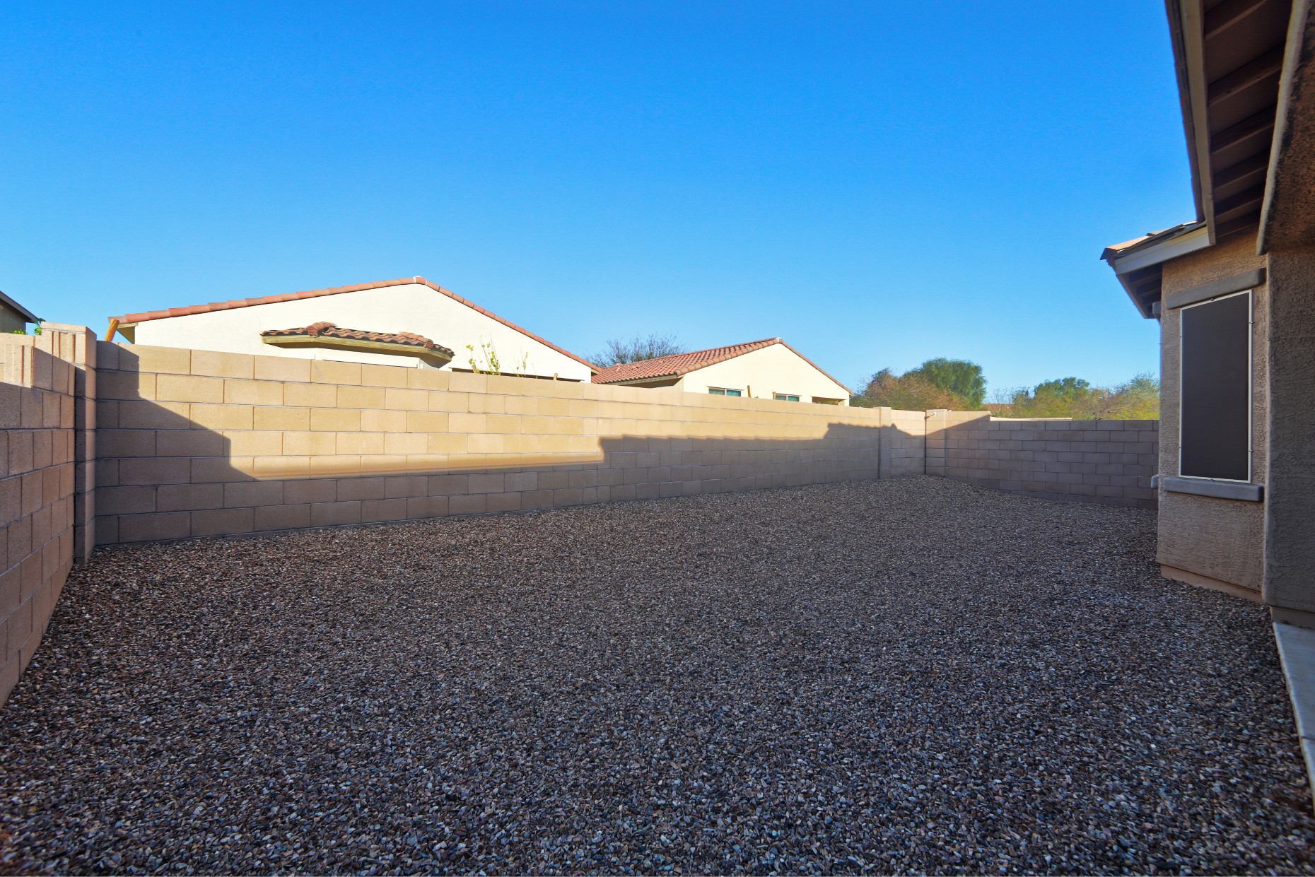 Spacious backyard with block wall privacy