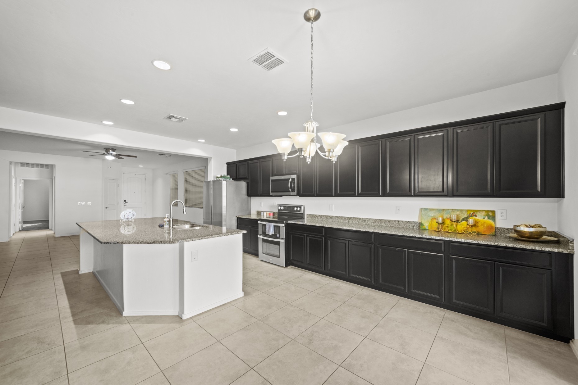 Kitchen with granite counters and dark cabinetry