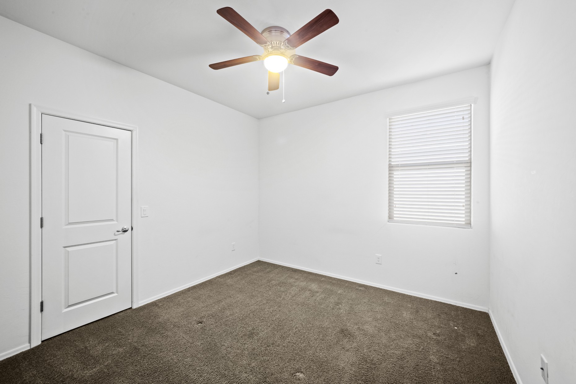 Second bedroom with carpet and ceiling fan