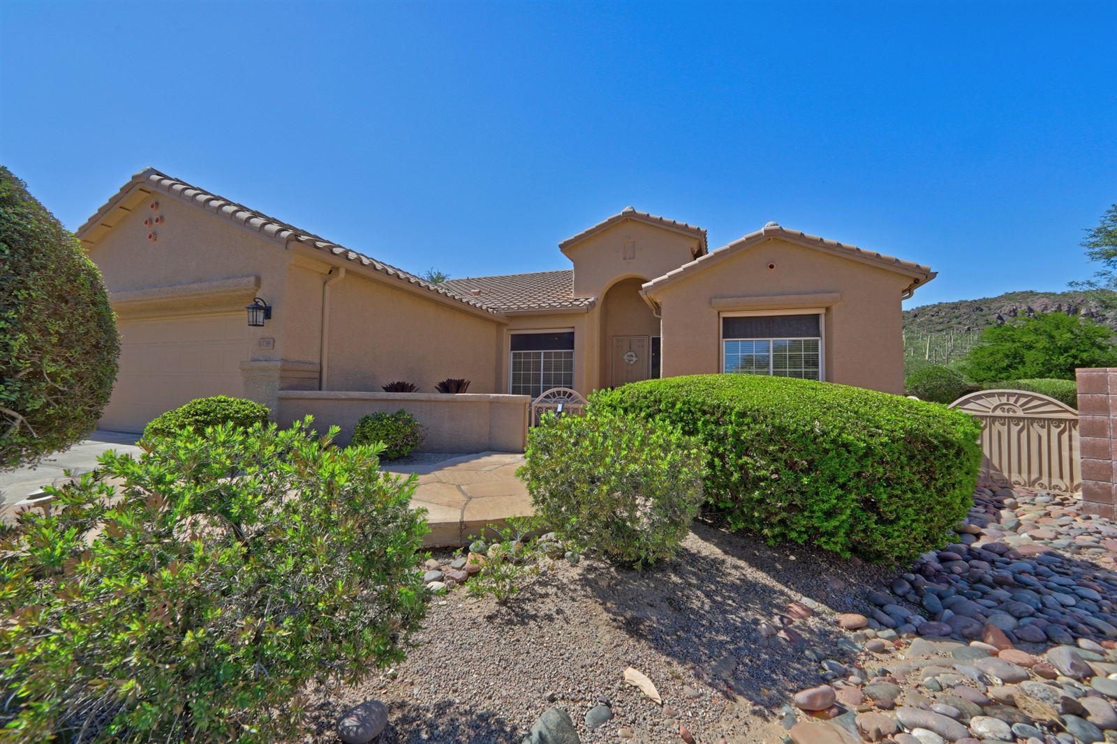 9339 N Whispering Shadows Way front exterior with saguaro-covered hills behind
